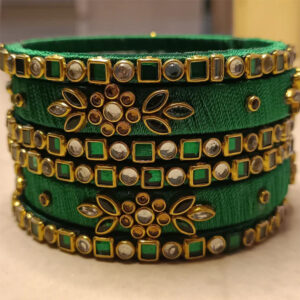 Emerald green and gold silk thread bangles in a premium product setting