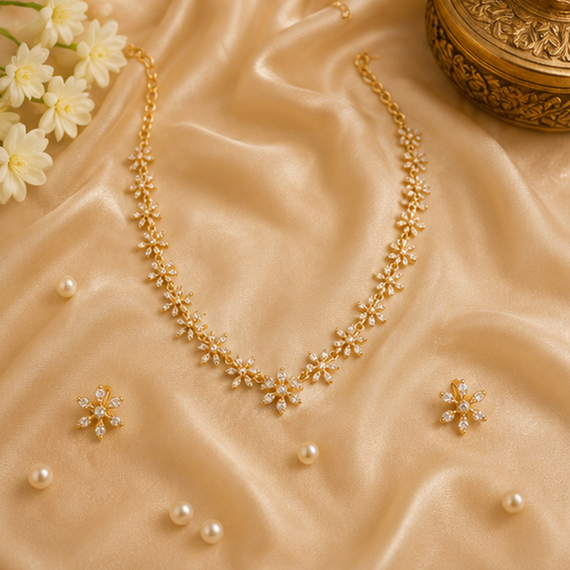 Golden Flower Charm Necklace Set on Silk Background