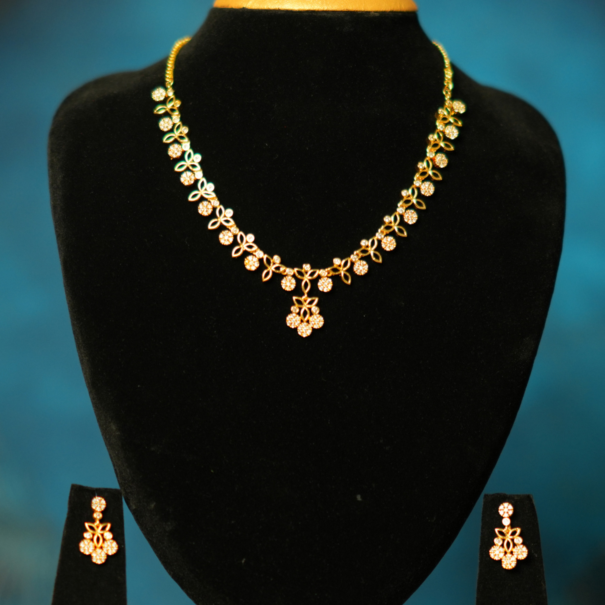 sklazo-golden-flower-charm-necklace-earring-set-1 Golden Flower Charm Necklace Set on Black Bust