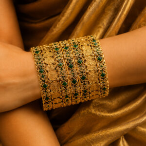Lakshmi gold silk thread bangles worn on a woman's arm