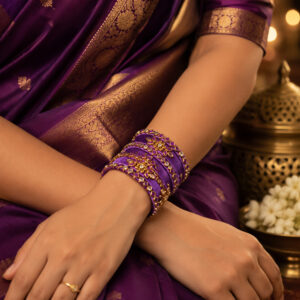Royal purple floral silk thread bangles worn by a woman