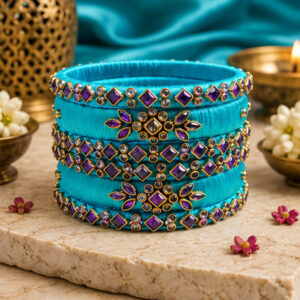 Sky blue and turquoise floral silk thread bangles on a premium display
