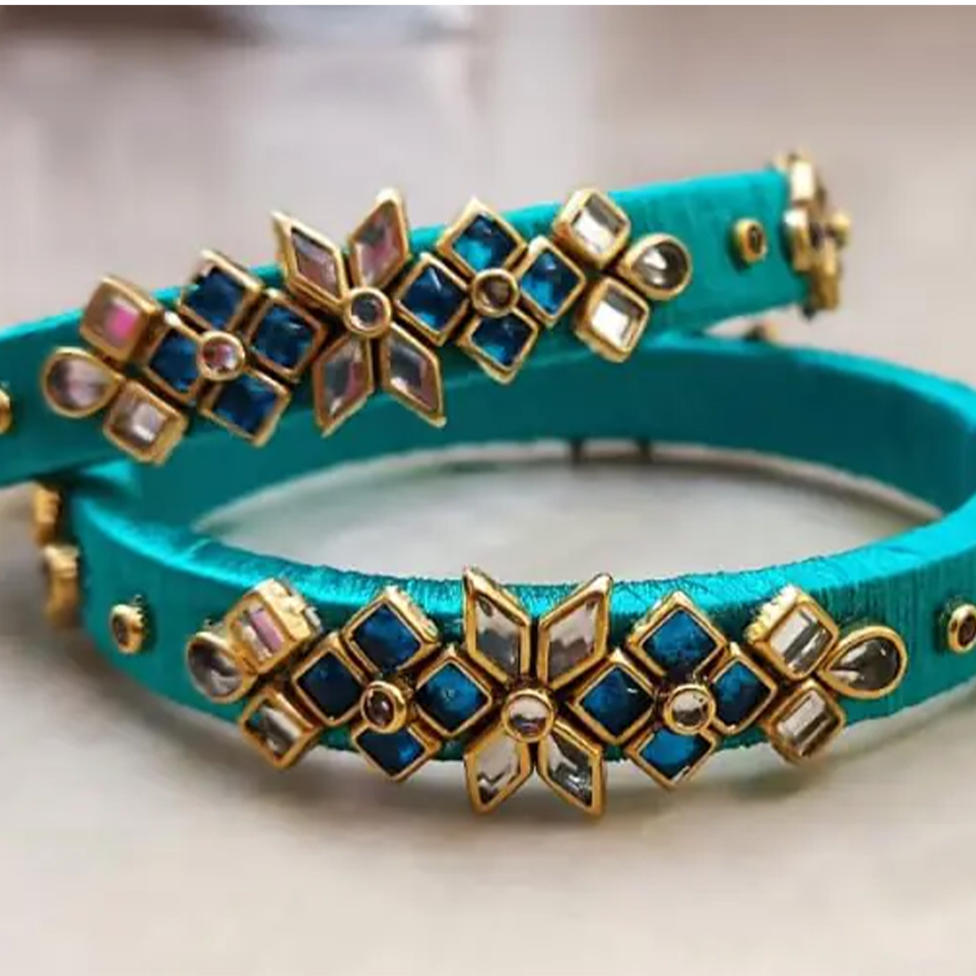 Sky blue and gold floral silk thread bangles close-up