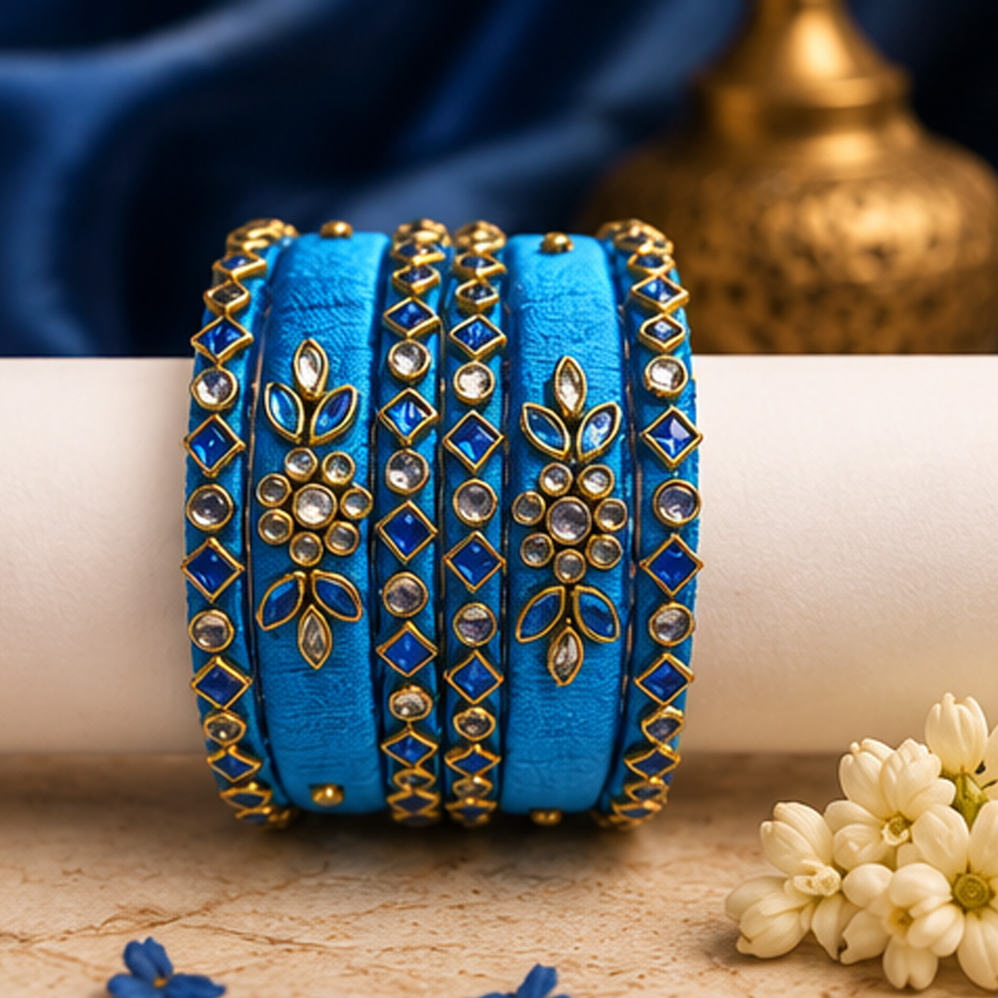 Sky blue and gold floral silk thread bangles in an elegant lifestyle setting